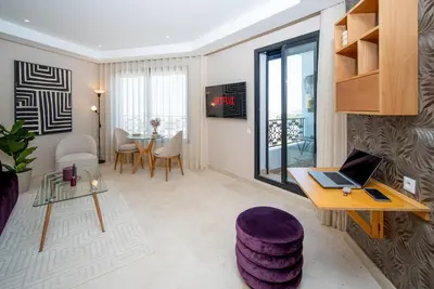 a living room with a laptop computer on a table at Gauthier Luxe , 1BR Apart- Comfort & Style in Casa in Casablanca