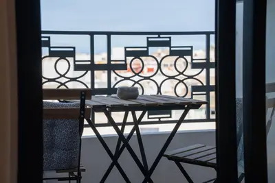 a table and two chairs on a balcony at Gauthier Luxe , 1BR Apart- Comfort & Style in Casa in Casablanca