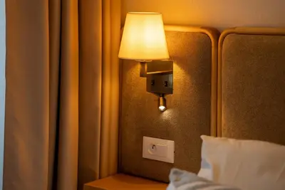 a lamp on the wall of a hotel room at Gauthier Luxe , 1BR Apart- Comfort & Style in Casa in Casablanca