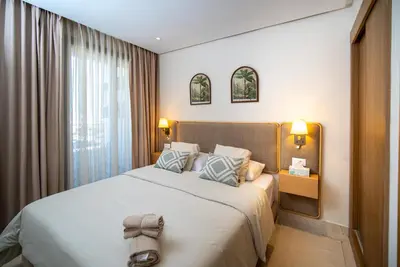 a bedroom with a large bed with two pillows at Gauthier Luxe , 1BR Apart- Comfort & Style in Casa in Casablanca