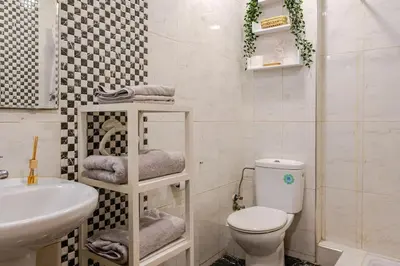 a bathroom with a white toilet and a sink at Appartement avec terrasse en plein centre de ville in Casablanca