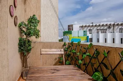 a wooden bench on the side of a building at Appartement avec terrasse en plein centre de ville in Casablanca