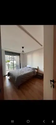 a bedroom with a bed and a large window at Cosy studio avec grande terasse et parking CFC in Casablanca
