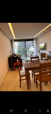 a living room with a table and chairs and a couch at Cosy studio avec grande terasse et parking CFC in Casablanca