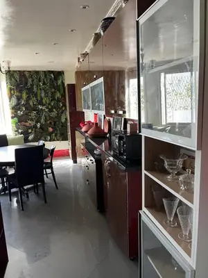 a kitchen with a counter and a table with chairs at Appartement Emil zola BELVÉDÈRE in Casablanca