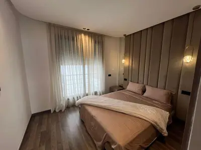 a bedroom with a bed and a large window at Appartement vaste et lumineux, Oasis in Casablanca