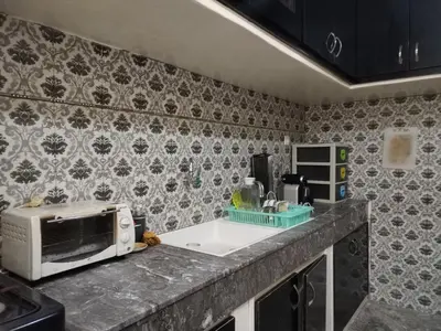a kitchen with a microwave and a sink at Sense housse in Rabat