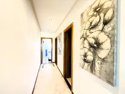 a painting of flowers on the wall in a hallway at Cosy sunny central - 2 BDR near train and tram in Casablanca