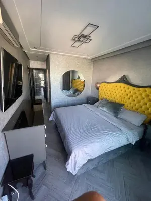 a bedroom with a large bed with a yellow headboard at Casablanca Bourgogne in Casablanca
