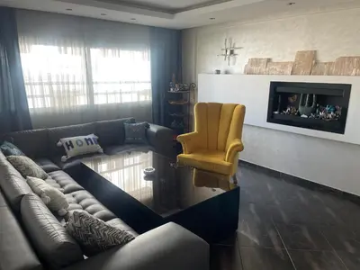 a living room with a couch and a chair at Casablanca Bourgogne in Casablanca