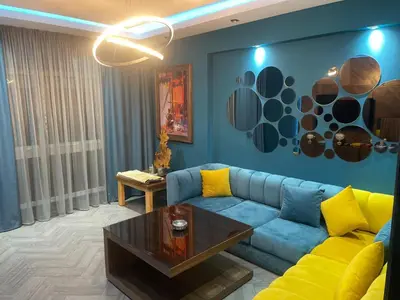 a living room with a blue couch and a table at Casablanca Bourgogne in Casablanca