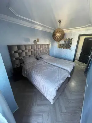 a large bed in a bedroom with a chandelier at Casablanca Bourgogne in Casablanca