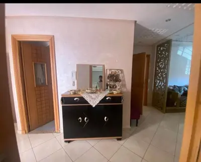 a black dresser with a mirror in a room at Duplex in Casablanca