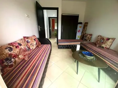 a living room with two couches and a table at Salam Beach, El Mansouria in Pont Blondin