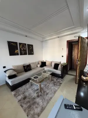 a living room with a couch and a table at Golden studio in Rabat