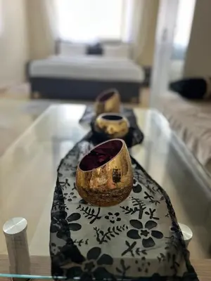 a glass table with three vases on top of it at Golden studio in Rabat