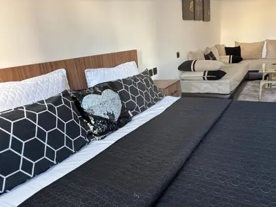 a bed with black and white pillows in a room at Golden studio in Rabat