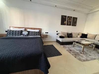 a bedroom with a bed and a couch at Golden studio in Rabat