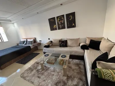 a living room with a couch and a table at Golden studio in Rabat