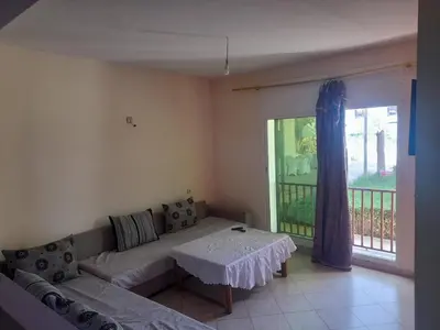 a living room with a couch and a table at Auberge les Roches in Al Haouamed