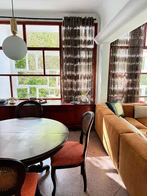a living room with a table and a couch at Cosy vintage appartement with terrace in Rabat