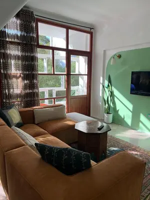a living room with a couch and a table at Cosy vintage appartement with terrace in Rabat