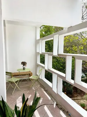 a room with white walls and a table at Cosy vintage appartement with terrace in Rabat