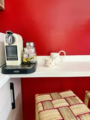 a kitchen counter with a toaster and cups on it at Cosy vintage appartement with terrace in Rabat