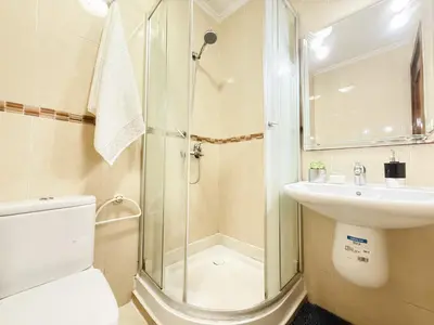 a bathroom with a shower and a toilet and a sink at Cosy sunny 2BR - central near train and tram in Casablanca