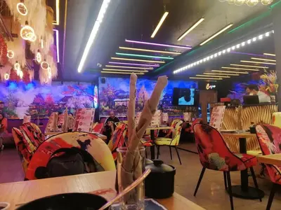 a dining room with tables and chairs and a stage at Cosy sunny 2BR - central near train and tram in Casablanca