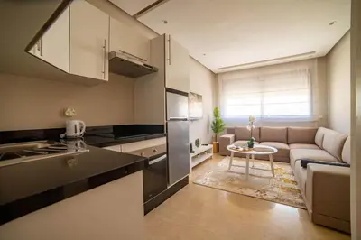 a kitchen and living room with a couch and a table at Studio au coeur de Casablanca in Casablanca