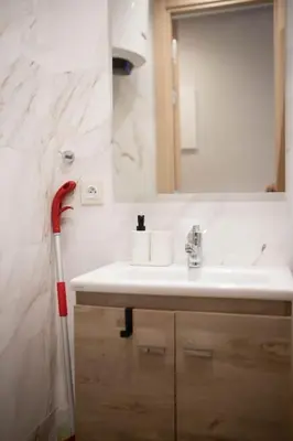 a bathroom with a sink and a red vacuum at Studio au coeur de Casablanca in Casablanca