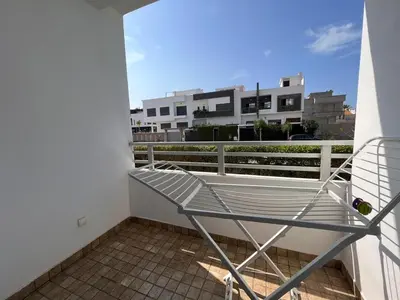 a metal rack on the balcony of a building at Salah in Bouznika