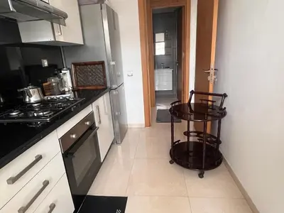 a kitchen with a stove and a cart in it at Salah in Bouznika