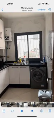 a kitchen with a washing machine and a window at Oasis beach in Mohammedia