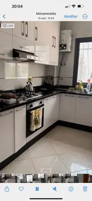 a kitchen with white cabinets and a stove top oven at Oasis beach in Mohammedia