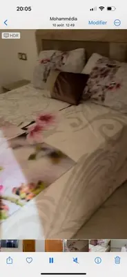 a picture of a bed with flowers on it at Oasis beach in Mohammedia