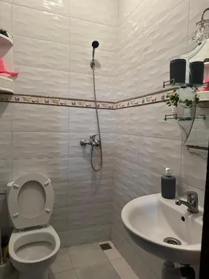 a bathroom with a toilet and a sink at appartement 3 min à Casa nearshore & Université Hassan 2 in Casablanca