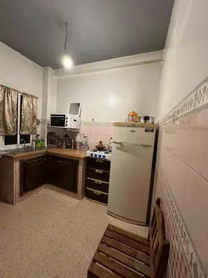 a small kitchen with a refrigerator and a sink at appartement 3 min à Casa nearshore & Université Hassan 2 in Casablanca