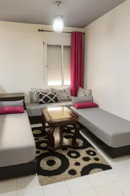 a living room with two couches and a coffee table at appartement 3 min à Casa nearshore & Université Hassan 2 in Casablanca