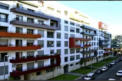 a large white building with cars parked in front of it at Elegant 2-Bedroom Apartment in Vibrant Maarif in Casablanca