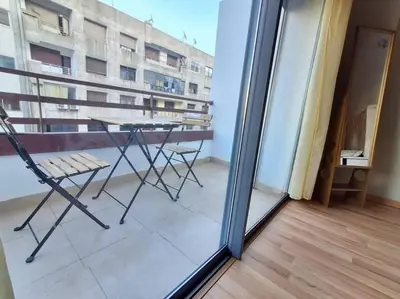a view of a balcony with a table and chairs at Elegant 2-Bedroom Apartment in Vibrant Maarif in Casablanca