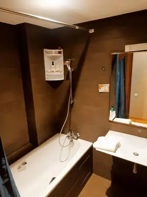 a bathroom with a white sink and a mirror at Elegant 2-Bedroom Apartment in Vibrant Maarif in Casablanca