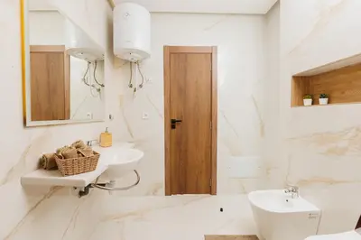 a white bathroom with a sink and a toilet at Perla in Rabat