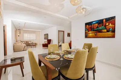 a dining room with a table and chairs at Perla in Rabat