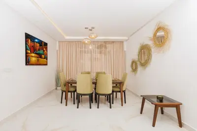 a dining room with a table and chairs at Perla in Rabat