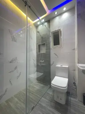 a bathroom with a shower and a toilet and a sink at Naj'Appartement de charme in Temara