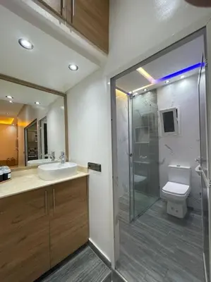 a bathroom with a toilet and a sink and a shower at Naj'Appartement de charme in Temara