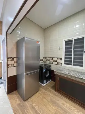 a kitchen with a stainless steel refrigerator and a stove at Naj'Appartement de charme in Temara