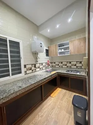a kitchen with a counter and a trash can at Naj'Appartement de charme in Temara